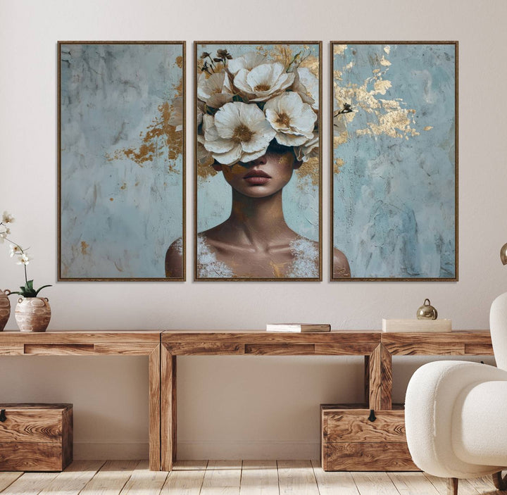 Golden Petal Wall Art: A womans face adorned with a gold floral design on a teal background, presented in a 3-panel modern glam canvas.