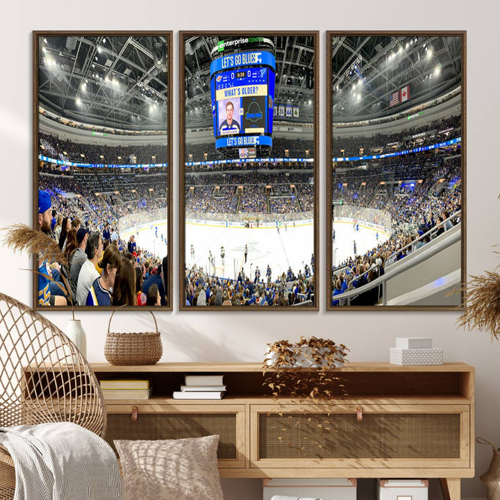 Wall art prints depicting the bustling scenes of the St. Louis Blues being cheered on by a full house at the Enterprise Center, beneath a large scoreboard.