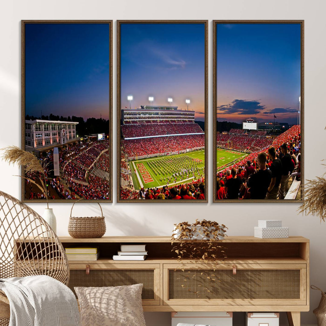 A vibrant and dynamic painting captures the essence of an electrifying night game at Carter-Finley Stadium, highlighting the illuminated atmosphere as the NC State Wolfpack competes under bright stadium lights.