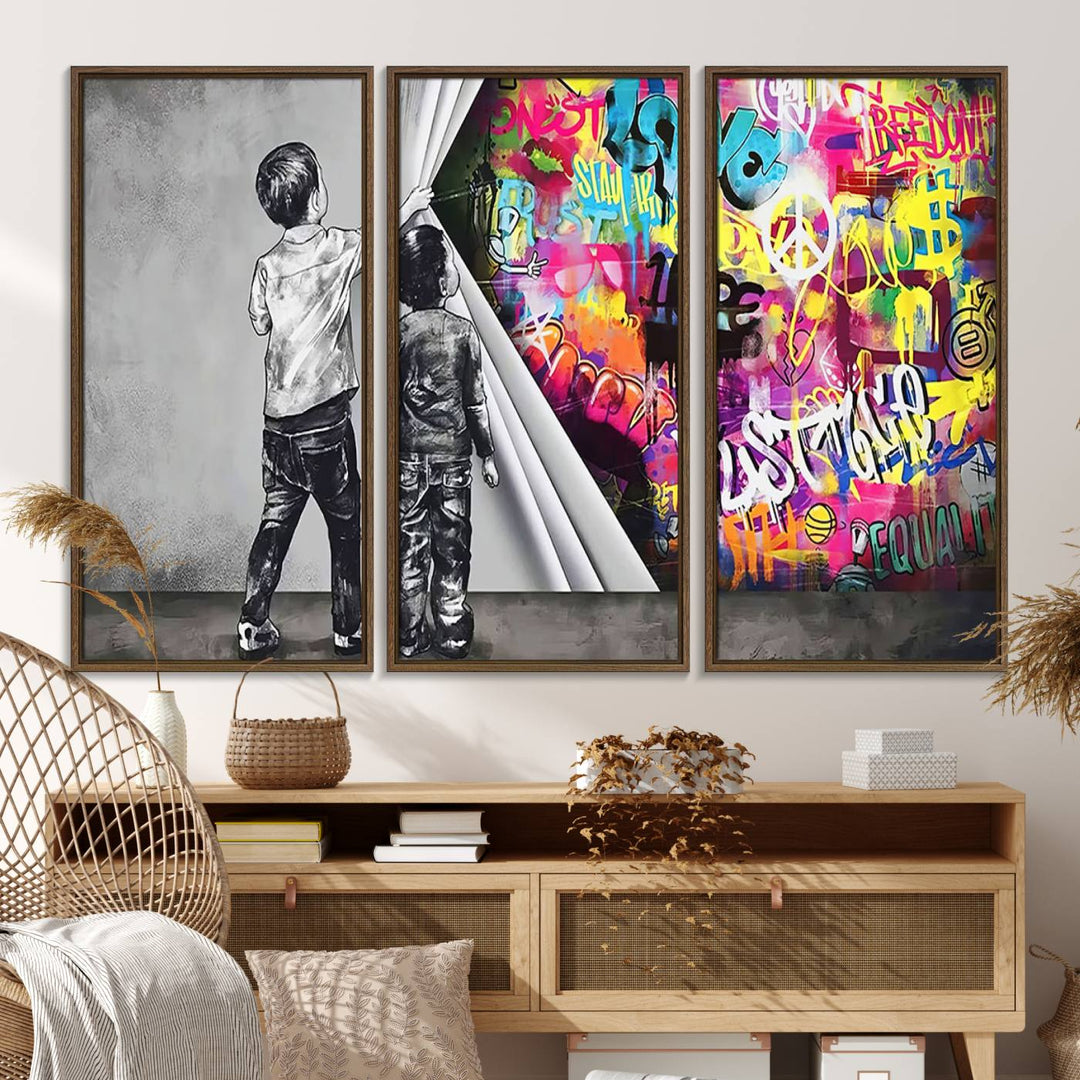 The Banksy Print - Street Art Canvas features a vibrant and bold image of two children lifting a curtain to reveal colorful graffiti. It's ready to hang, adding an urban modern decor vibe.