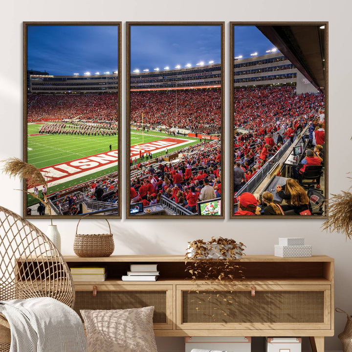 A vibrant wall art captures the essence of Madison Camp Randall Stadium, depicting a sea of fans in red and white during a Wisconsin Badgers football game under bright lights.