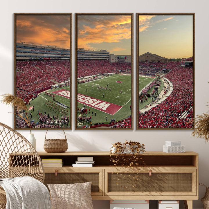 The wall features a Wisconsin Badgers wall art canvas print, capturing the vibrant atmosphere of a full Camp Randall Stadium at sunset.