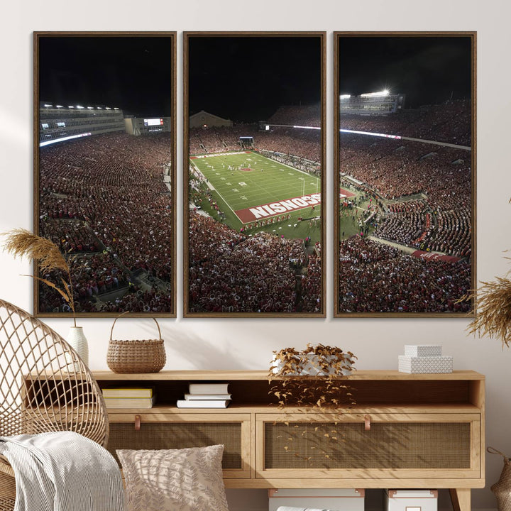 A painting of a stadium packed for a Wisconsin Badgers game, with WISCONSIN clearly visible in the end zone at Camp Randall Stadium.