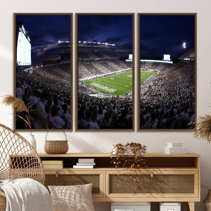 A packed football stadium at night, with bright lights and fans in white, depicted in a Michigan State Spartans Stadium wall art.