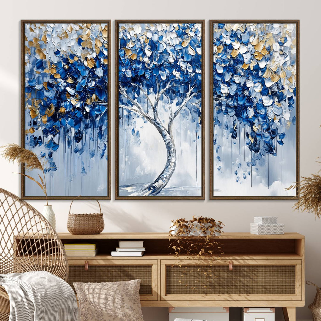 The Blue and Gold Abstract Tree Wall Art showcases a swirl trunk and features blue, silver, and gold leaves on a framed canvas print.