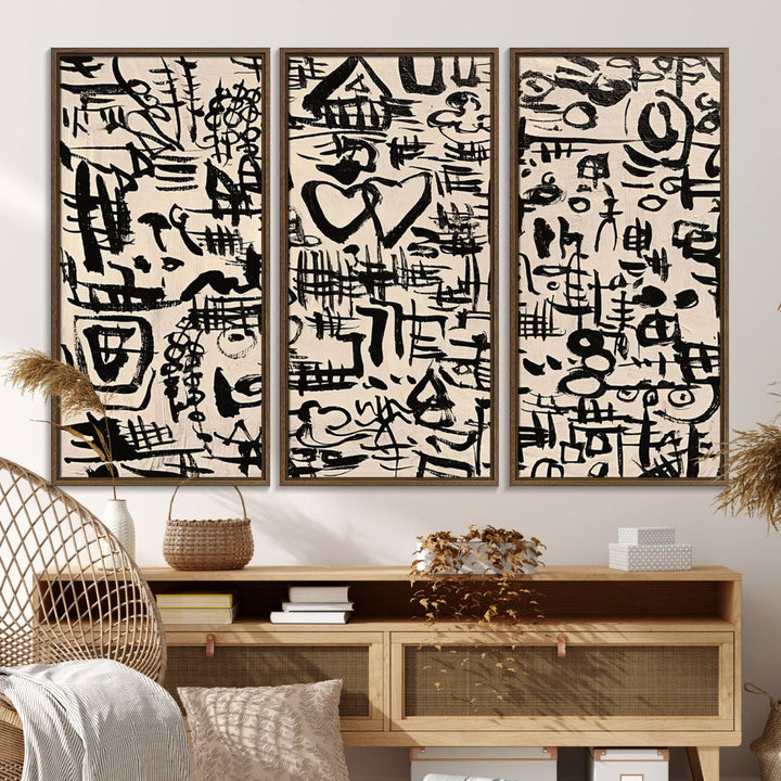 The Abstract Love and Chaos canvas is a museum-quality print featuring black symbols on a beige background, adorned with a heart and scribble design. It is framed to enhance its artistic appeal.