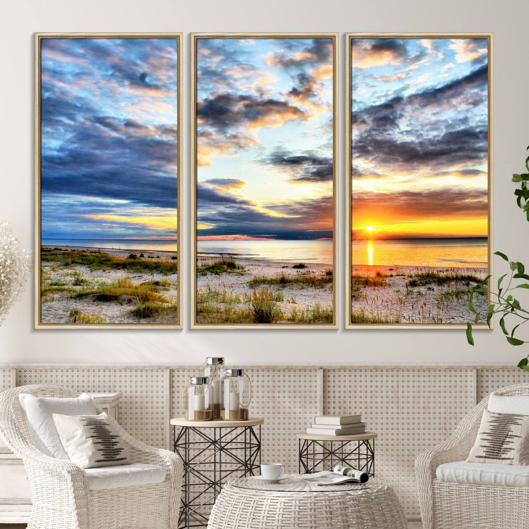 The Sunset On The Ocean canvas wall art features a beautiful beach sunset with grass and clouds.