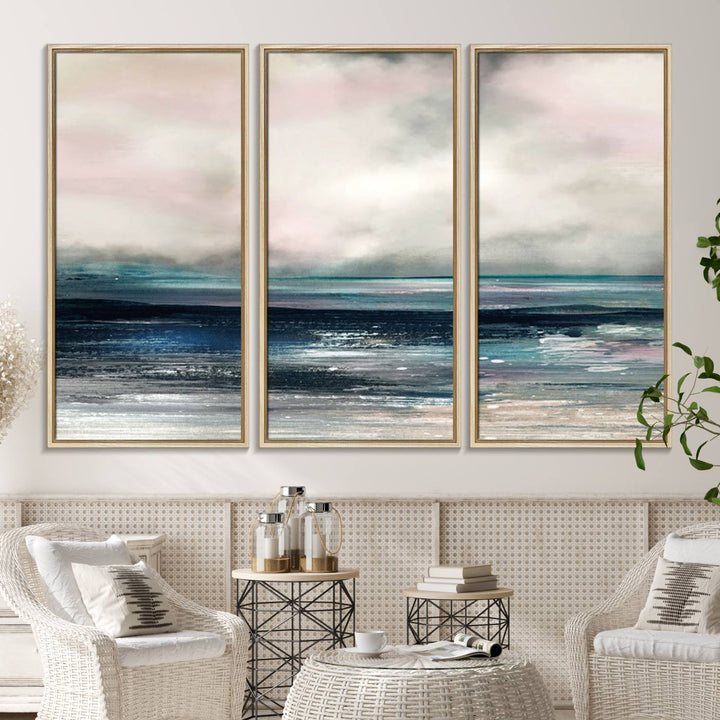 A contemporary abstract wall art canvas print in pastel pink, teal, and gray tones hangs on the wall.