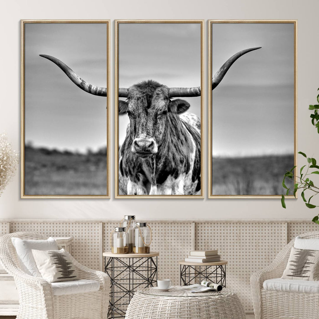 The Texas Longhorn Cow wall art, divided into three panels, is of gallery quality and displayed on a dark wall.