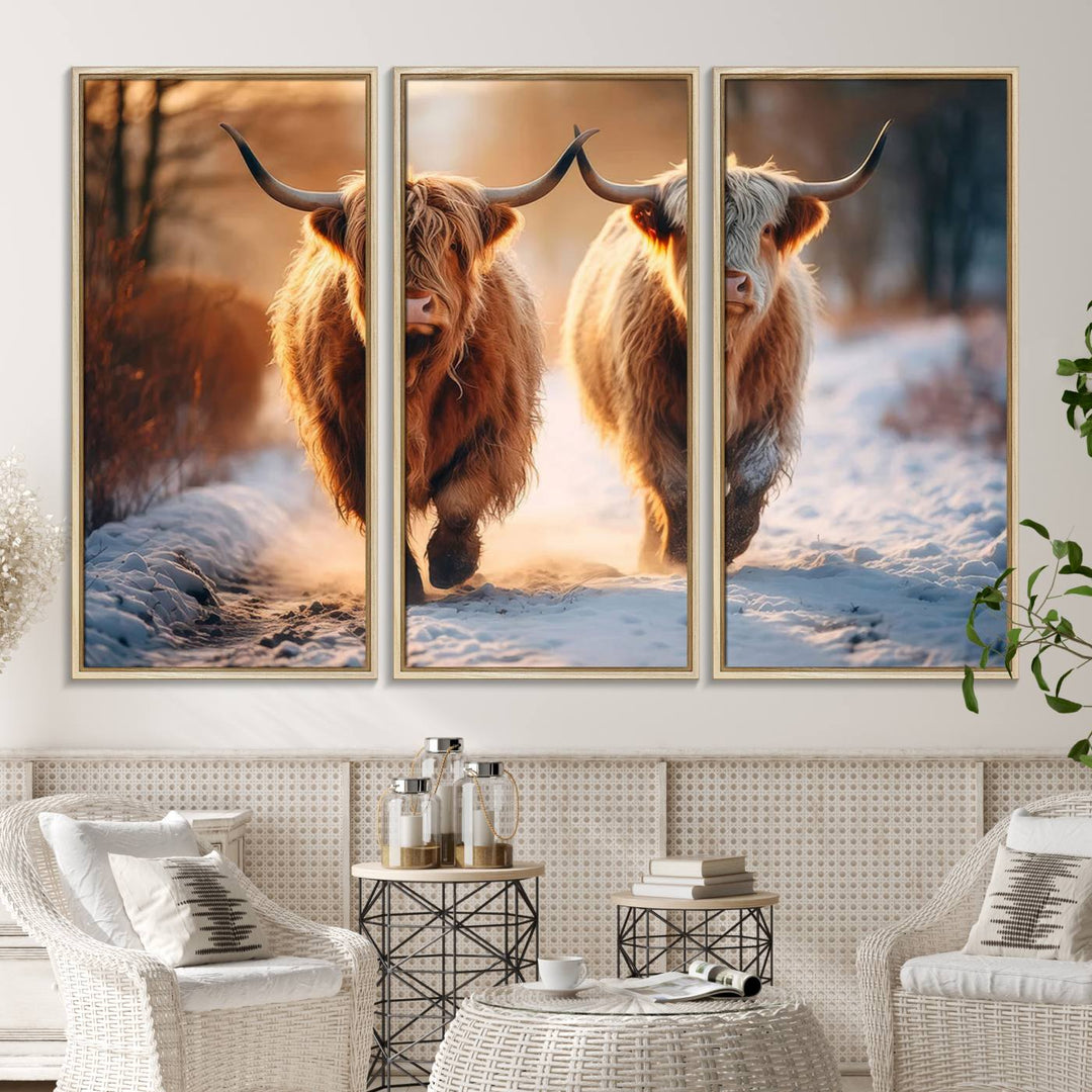 The wall art is a Scottish Highland Cow Horn canvas print featuring cows on a snowy path bathed in warm sunlight, serving as a rustic decor piece.