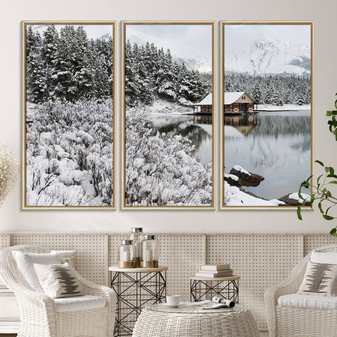 Experience the beauty of winter with the "Cabin by the Lake Canvas Wall Art," showcasing a serene snowy landscape. This rustic nature decor features a cozy cabin nestled amid snow-laden trees, set against a breathtaking mountain view, perfect for enhancing your living room.