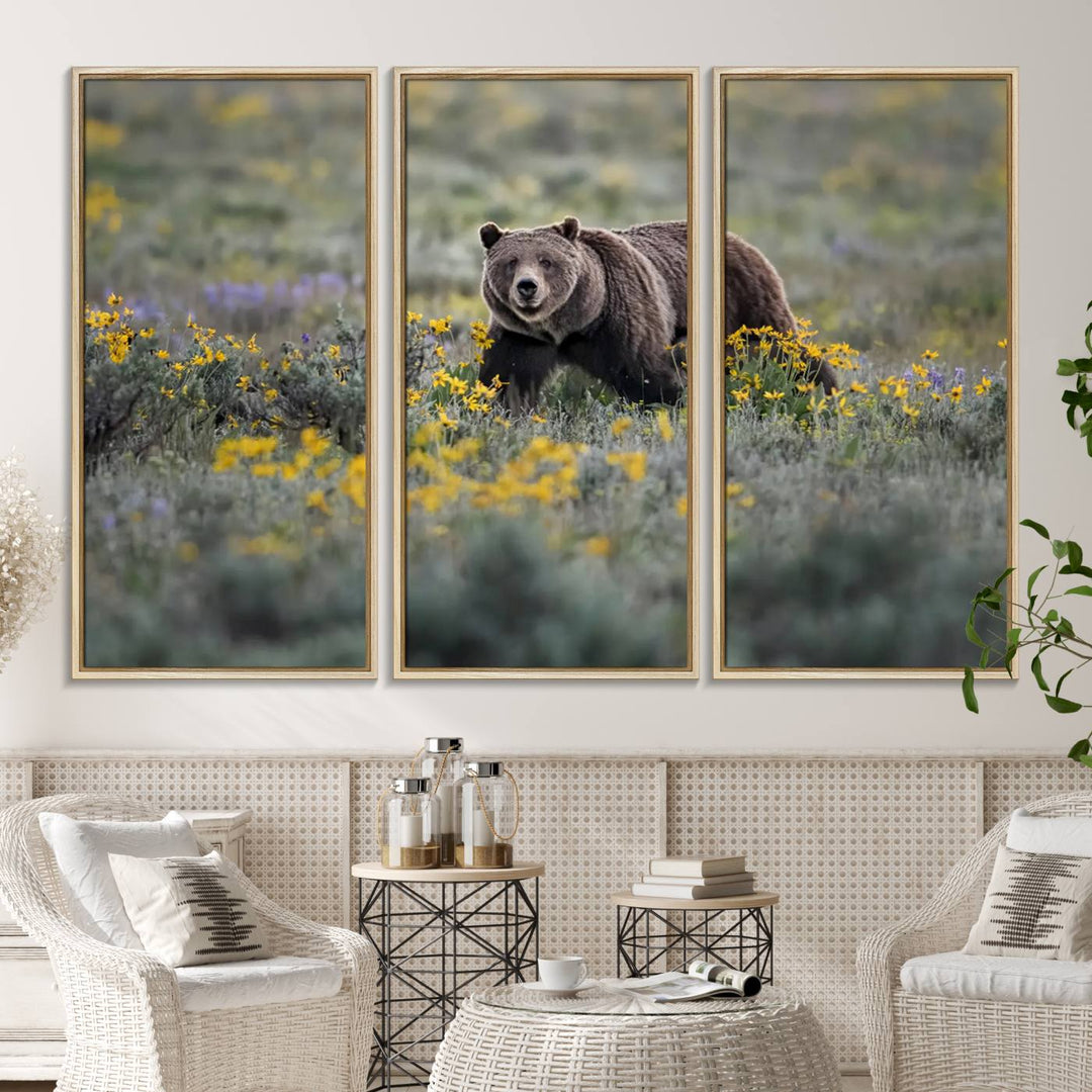 The "Grizzly 399 in Wild Flowers Wall Art Canvas Print" features a grizzly bear strolling through a field of yellow and purple flowers, beautifully showcased as a triptych. This handcrafted piece, proudly made in the USA, adds charm and sophistication to your space.