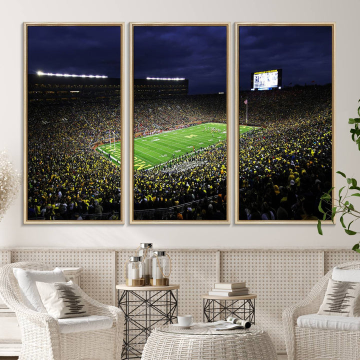 A painting of the packed Michigan Wolverines football stadium at night.