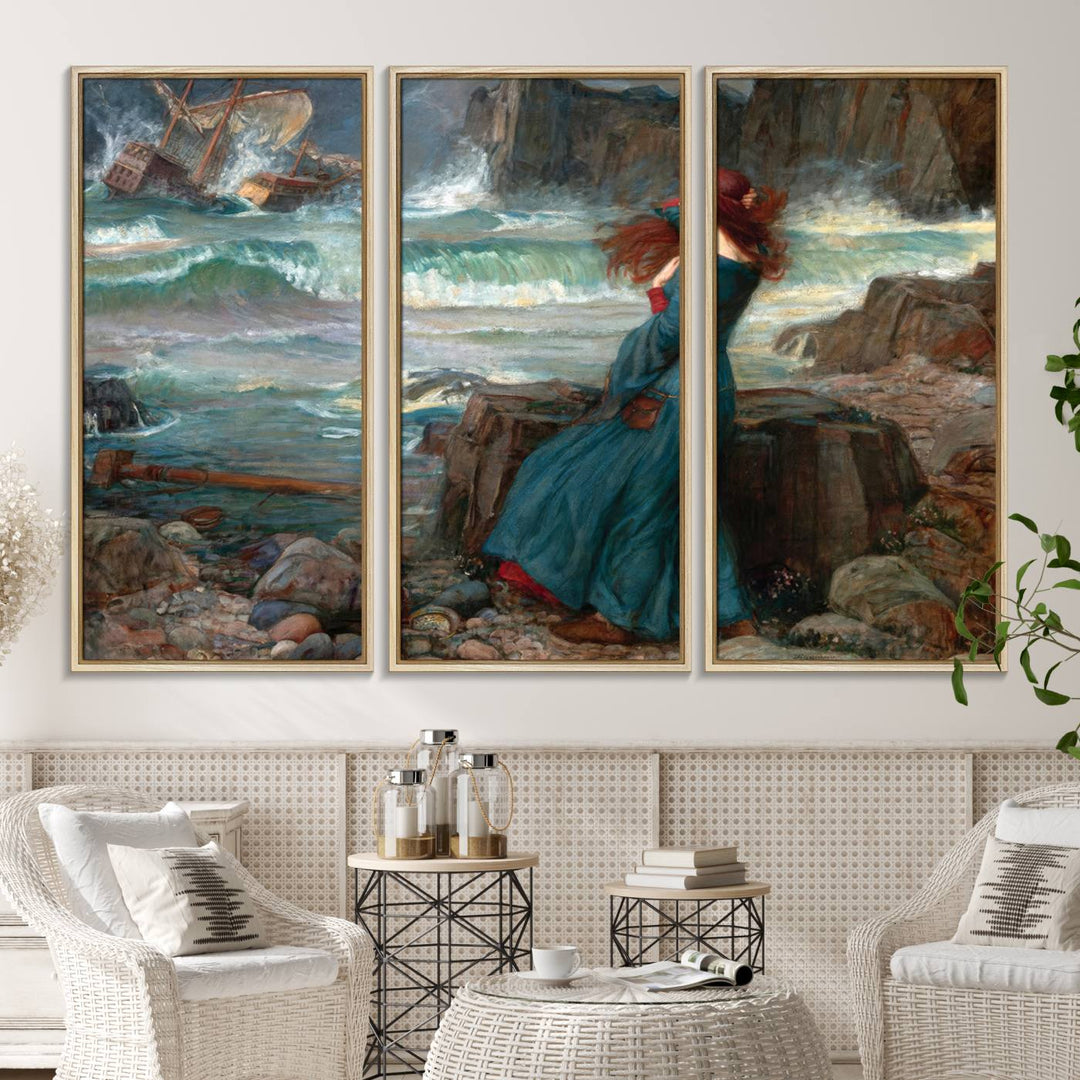 The Miranda by the Shore Wall Art Canvas Print depicts a woman in a blue dress standing by the sea, watching a shipwreck.