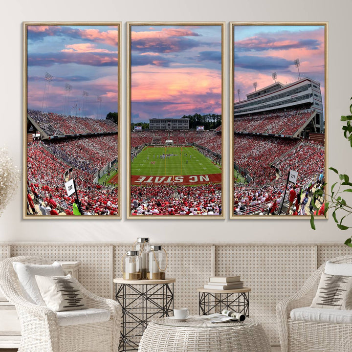 The wall art captures an NC State Wolfpack game under a vibrant sunset on triple canvas.