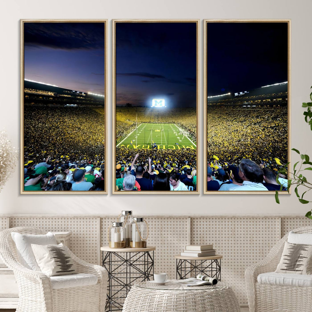 The wall art features a glowing M in this Michigan Wolverines Football Team Ann Arbor Stadium Canvas Print.