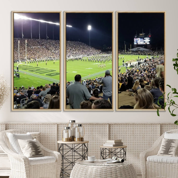 A painting depicting the Purdue Boilermakers football game at Ross-Ade Stadium is illuminated under gallery-quality lights.