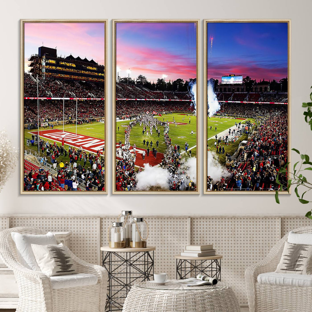 The wall art features a canvas print of the Stanford Cardinal football team, capturing players, fireworks, and smoke against the backdrop of a sunset at Stanford Stadium.