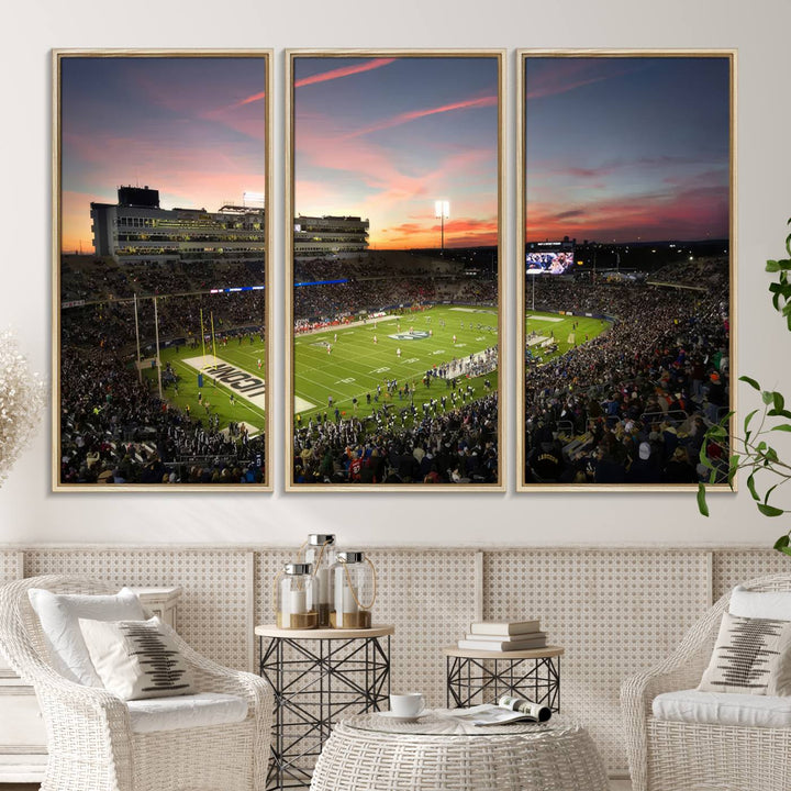 This wall art canvas print captures UCONN Huskies fans energizing a sunset scene at East Hartfords Pratt & Whitney Stadium.