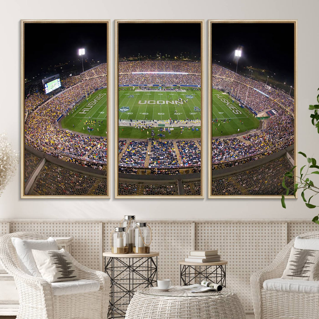 A large football stadium at night, featuring the UCONN Huskies, is depicted on the East Hartford Pratt & Whitney Stadium Wall Art Canvas Print.