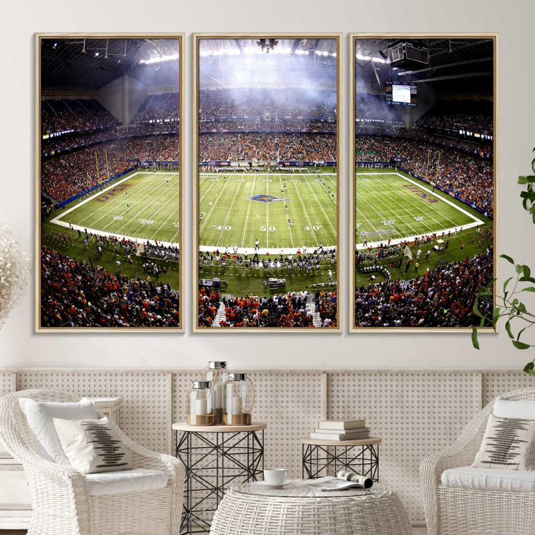 The modern living room features an Alamodome wall art canvas print, depicting a stadium filled with spectators for a UTSA Roadrunners game.