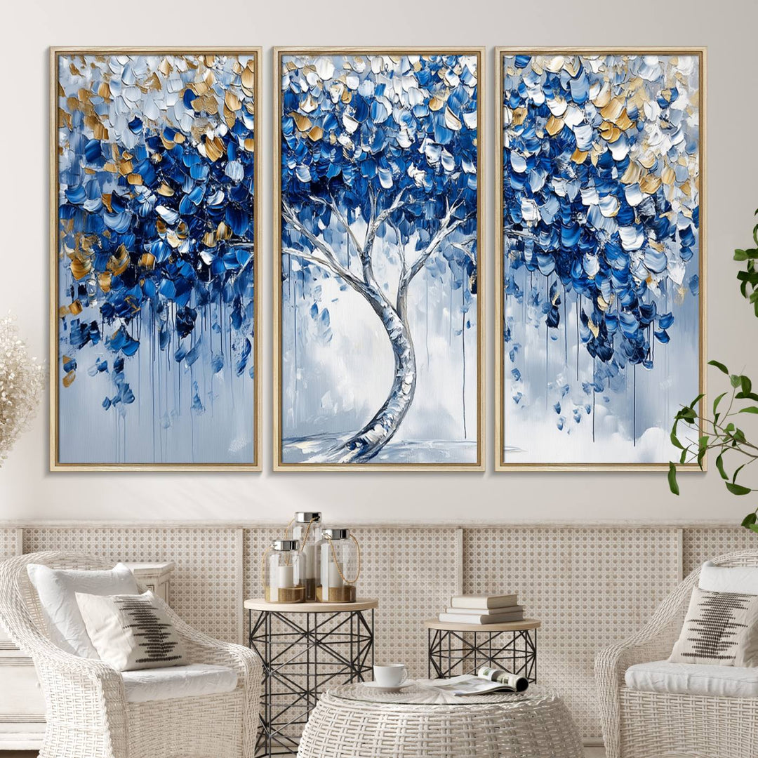 The Blue and Gold Abstract Tree Wall Art showcases a swirl trunk and features blue, silver, and gold leaves on a framed canvas print.