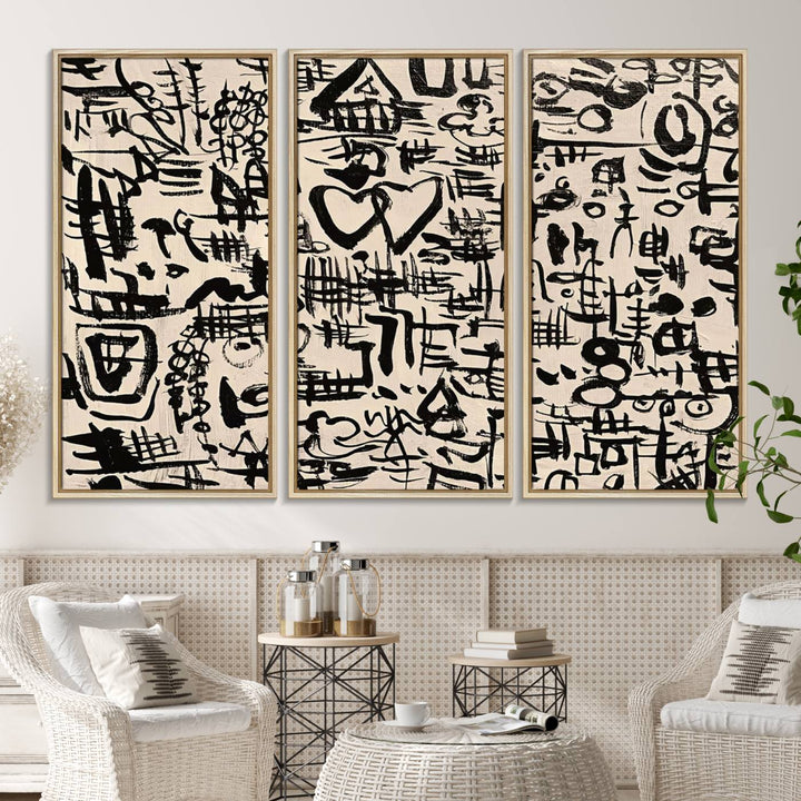 The Abstract Love and Chaos canvas is a museum-quality print featuring black symbols on a beige background, adorned with a heart and scribble design. It is framed to enhance its artistic appeal.