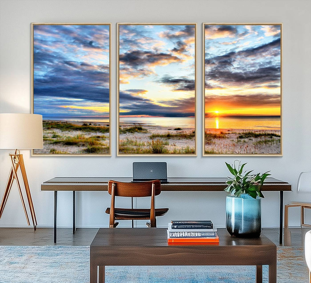 The Sunset On The Ocean canvas wall art features a beautiful beach sunset with grass and clouds.