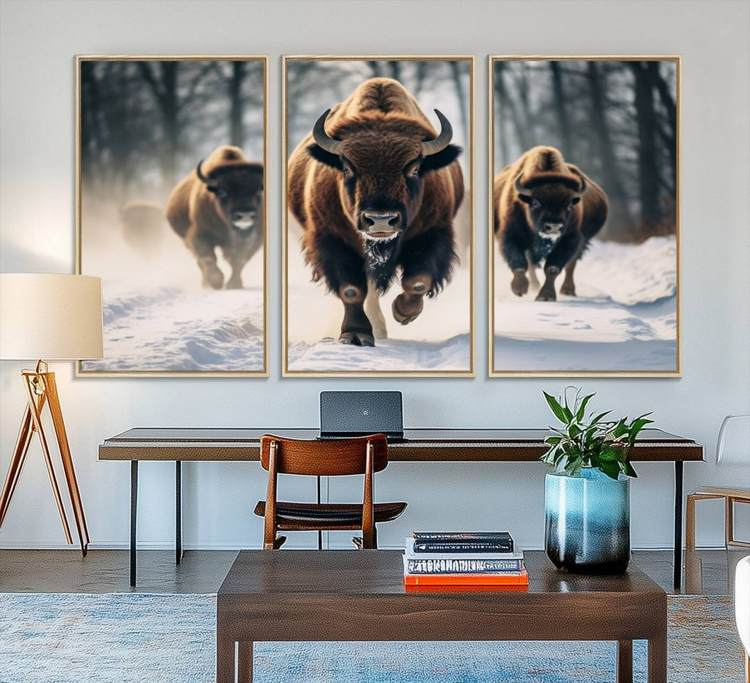 Wall art titled Cow Bighorn shows three bison running through snow in a forest.