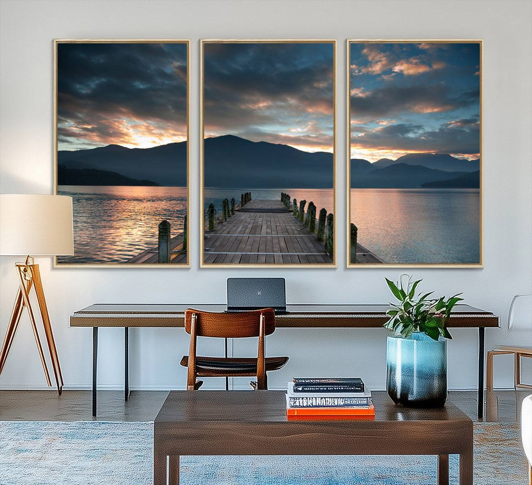 The Mountain Lake Wood Pier Canvas Wall Art depicts a serene lake and mountains, enhancing the beauty of any space.