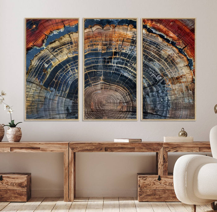 The Abstract Tree Ring Wall Art in orange, blue, and gray perfectly complements minimalist nature-inspired home decor.