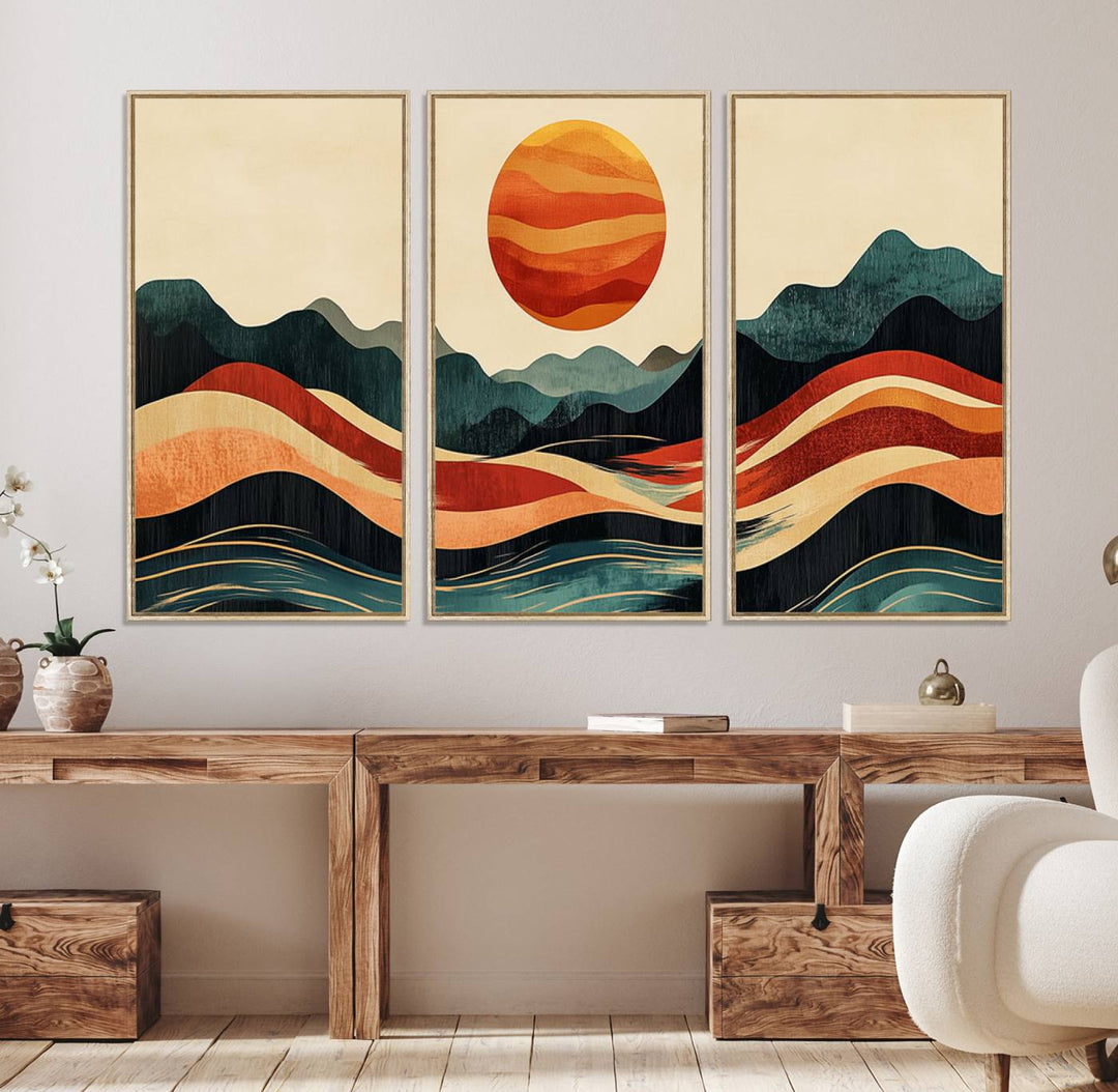 The Mountain Triptych wall art, featuring a design of the sun, mountains, and waves, is displayed prominently on the wall.