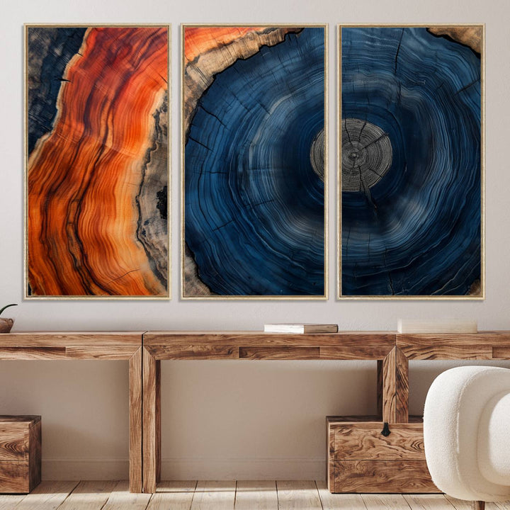 Abstract Tree Ring Wall Art Print on canvas featuring vibrant blue, orange, and brown rings with a natural rustic wood texture. Free shipping available!.