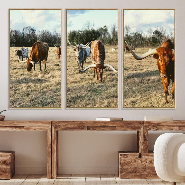 A herd of Texas Longhorn cattle grazing in an open field under a partly cloudy sky, capturing a rustic and Western ranch aesthetic.