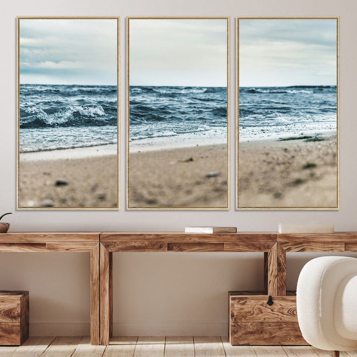 A moody ocean scene with gentle waves washing onto a sandy beach under a cloudy sky, creating a peaceful and coastal atmosphere.