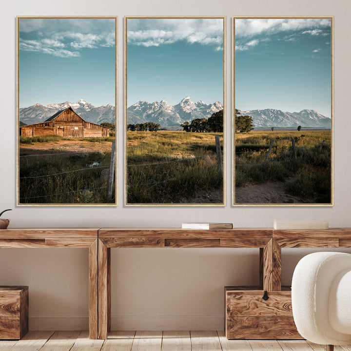 A rustic farmhouse with a wooden barn set against majestic mountain peaks under a soft blue sky, evoking peaceful countryside charm.
