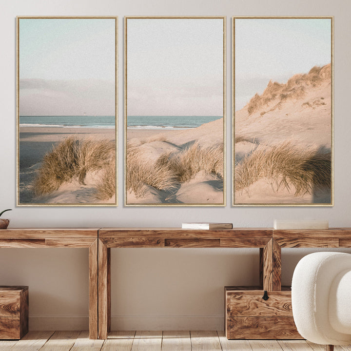Soft pastel-toned beach scene with sand dunes, windswept grasses, and a calm ocean horizon, creating a serene coastal atmosphere.