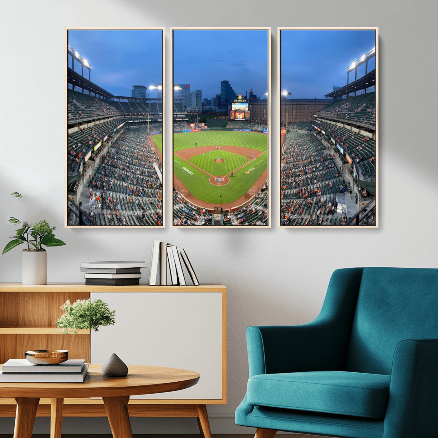 Wide panoramic view of a baseball stadium at dusk with players on the field, stadium lights illuminating the scene, and a sparse crowd of spectators in the stands.