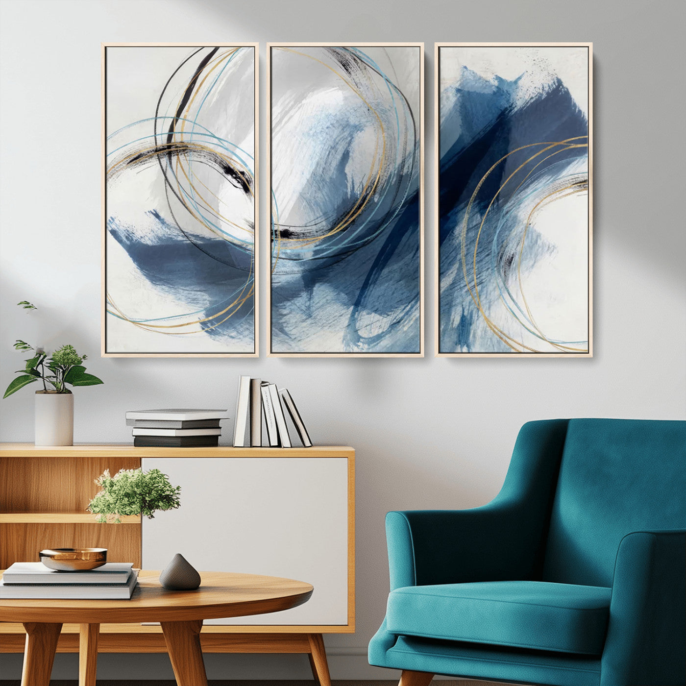 Abstract wall art featuring dynamic brush strokes in shades of blue and gray, overlaid with delicate circular line patterns in gold, black, and light blue on a white background.