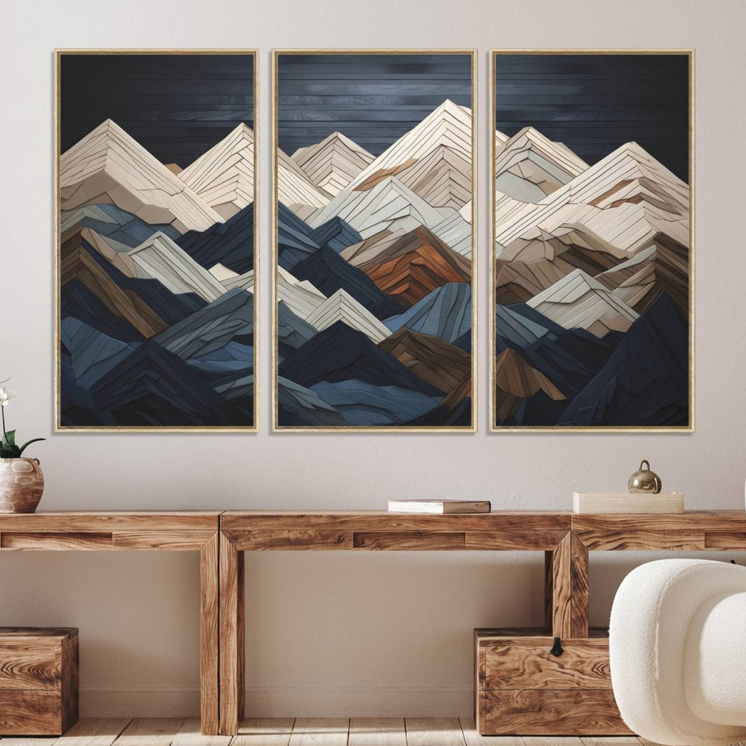 A geometric mountain range wood style wall art in shades of blue, gray, and brown; a 3-piece abstract set perfect for modern rustic decor.