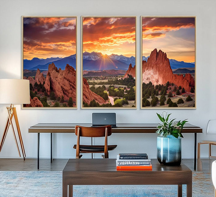 A vibrant sunset over the Rocky Mountains with red rocks.