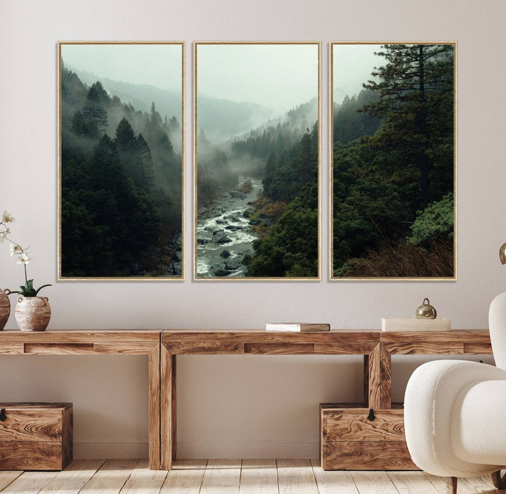 The Misty Forest Wall Art features a serene landscape with a misty river and evergreens, ideal for enhancing the ambiance of any living room or cabin.