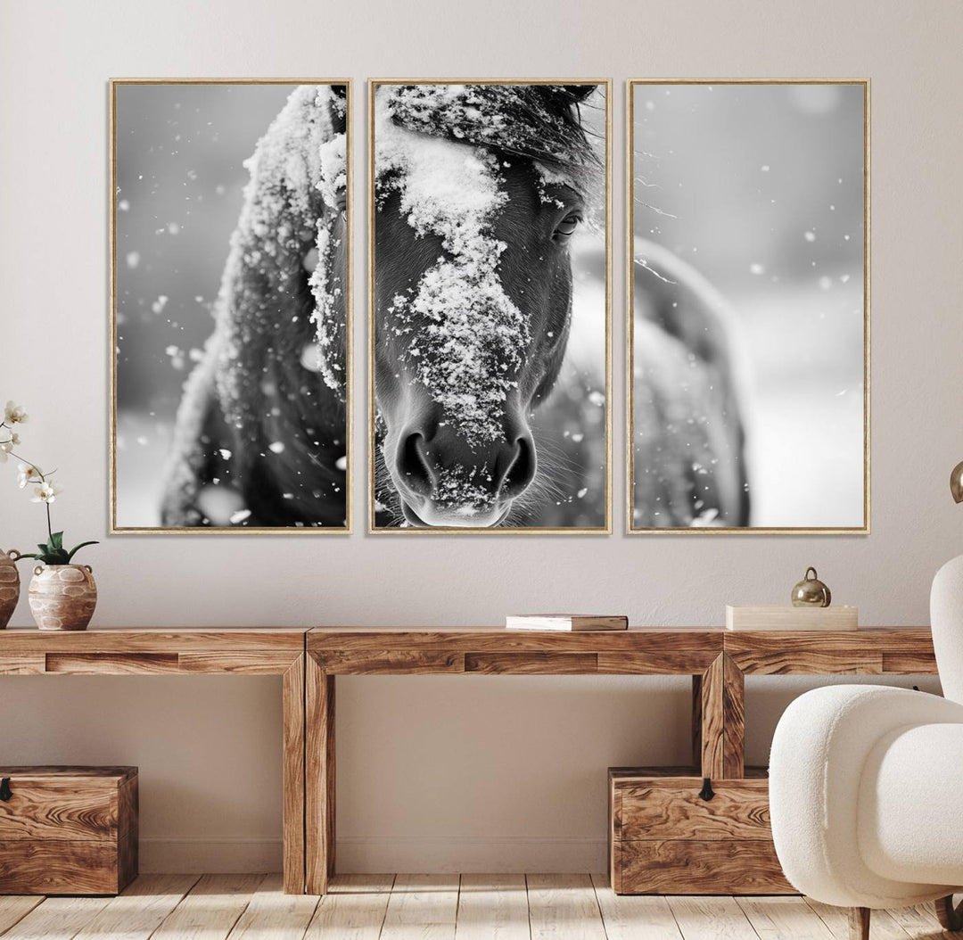 The Black and White Horse Winter Wall Art features a majestic horse with snow-covered hair set against a serene winter backdrop.