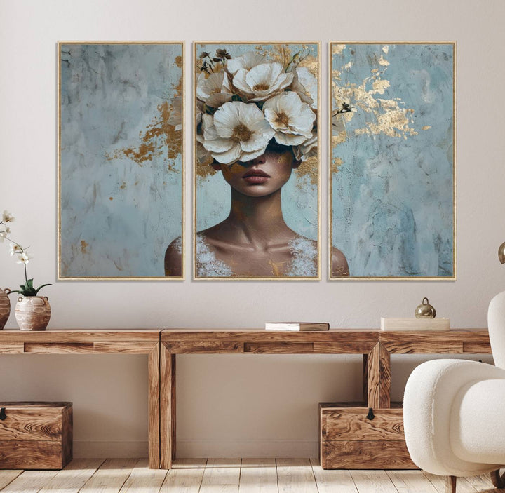 Golden Petal Wall Art: A womans face adorned with a gold floral design on a teal background, presented in a 3-panel modern glam canvas.