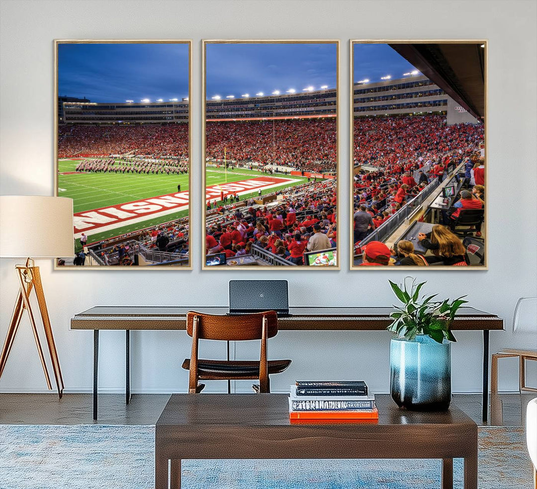 A vibrant wall art captures the essence of Madison Camp Randall Stadium, depicting a sea of fans in red and white during a Wisconsin Badgers football game under bright lights.