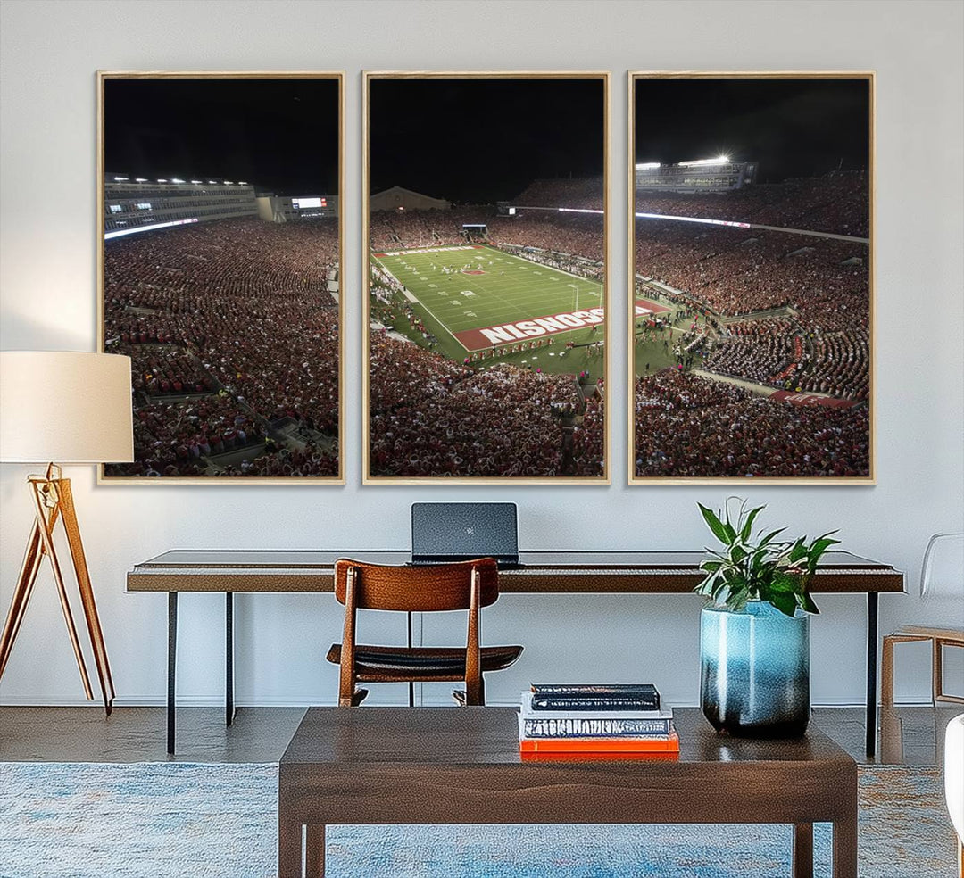 A painting of a stadium packed for a Wisconsin Badgers game, with WISCONSIN clearly visible in the end zone at Camp Randall Stadium.