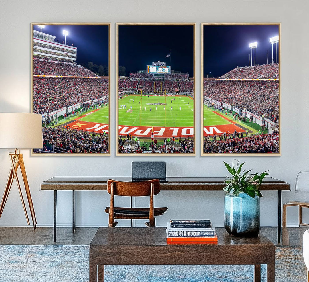 The wall art titled Wolfpack Football Team Print features Raleigh Carter-Finley Stadium at night, reproduced on premium canvas.