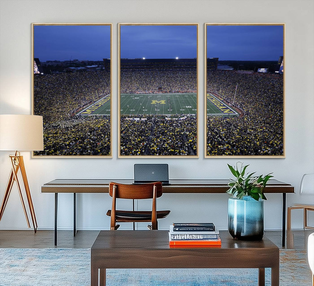 Wall art featuring an aerial shot of Michigan Stadium at dusk, showcasing the University of Michigan Wolverines M logo.