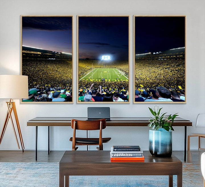 The wall art features a glowing M in this Michigan Wolverines Football Team Ann Arbor Stadium Canvas Print.