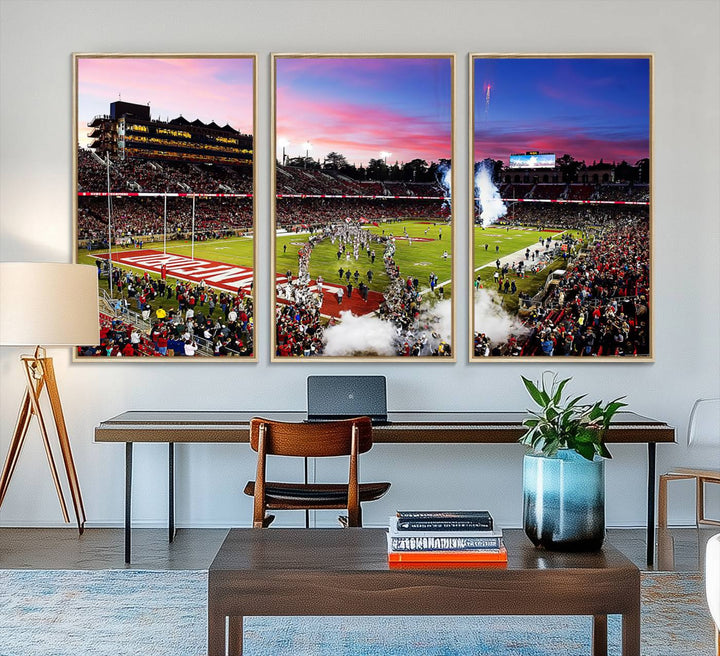 The wall art features a canvas print of the Stanford Cardinal football team, capturing players, fireworks, and smoke against the backdrop of a sunset at Stanford Stadium.